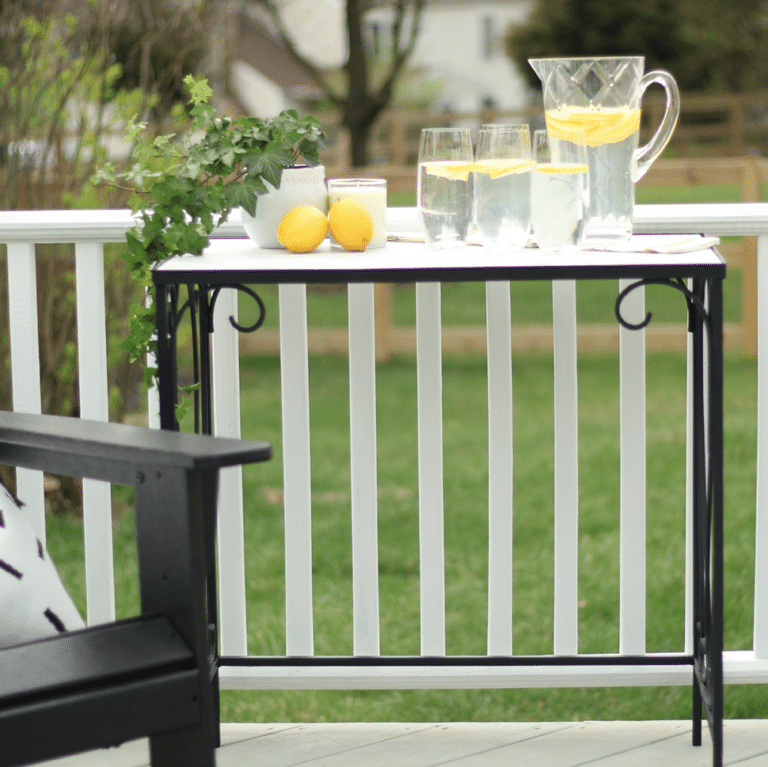 Wrought iron table with faux marble top on deck