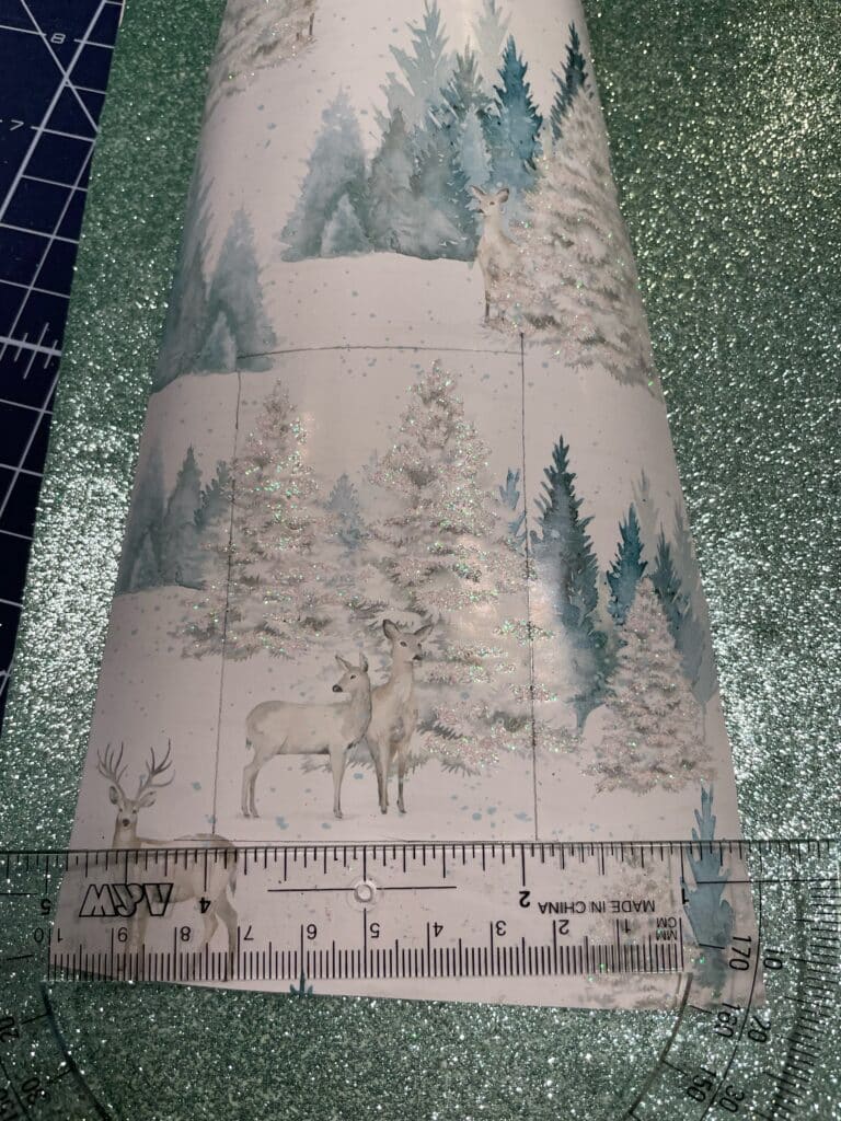 A patterned wrapping paper with a line drawn to indicate where to cut to make DIY gift tags