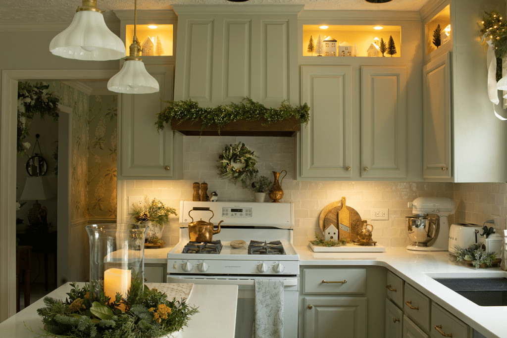 A European farmhouse style kitchen showing open cubbies and a range hood deocorated for Christmas.