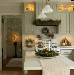 European farmhouse style kitchen featuring range hood decorated for Christmas