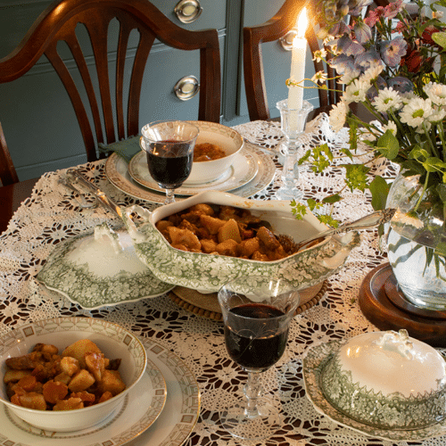 Easy beef stew in a soup tureen on a dining room table