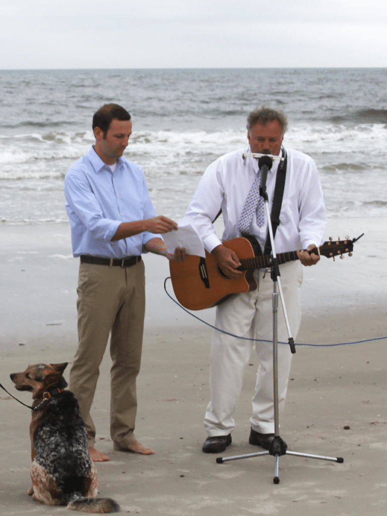 A guitar player on a beach