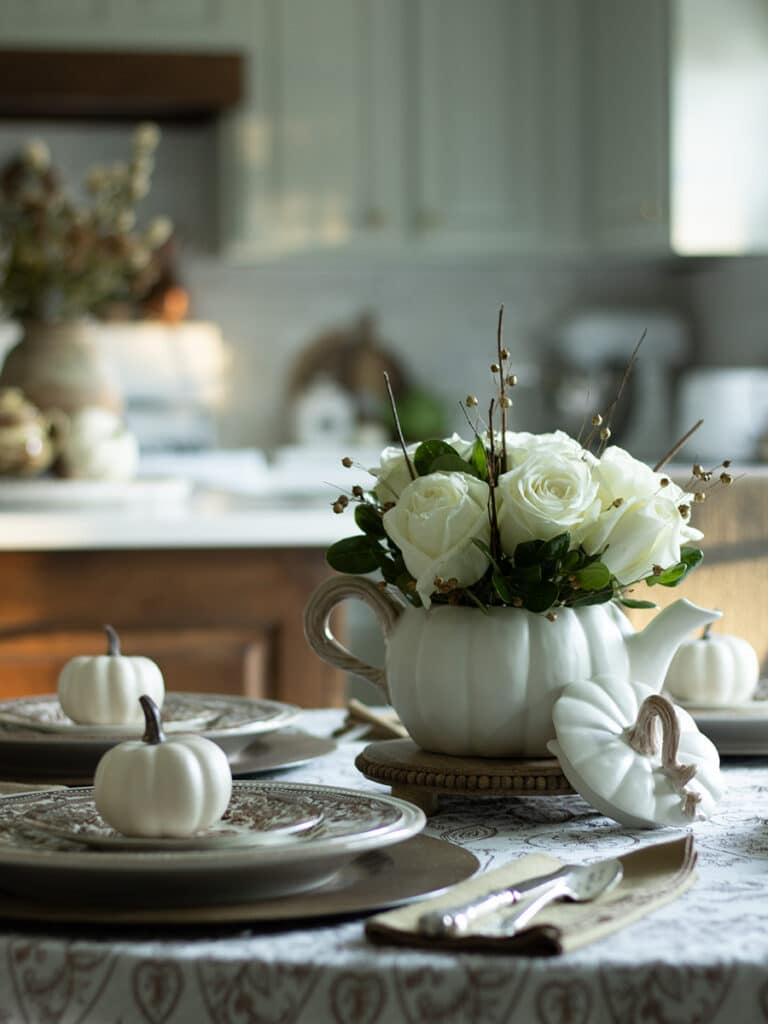 A pumpkin bowl filled with white roses