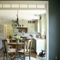The view into a kitchen through a cased opening that houses a transom
