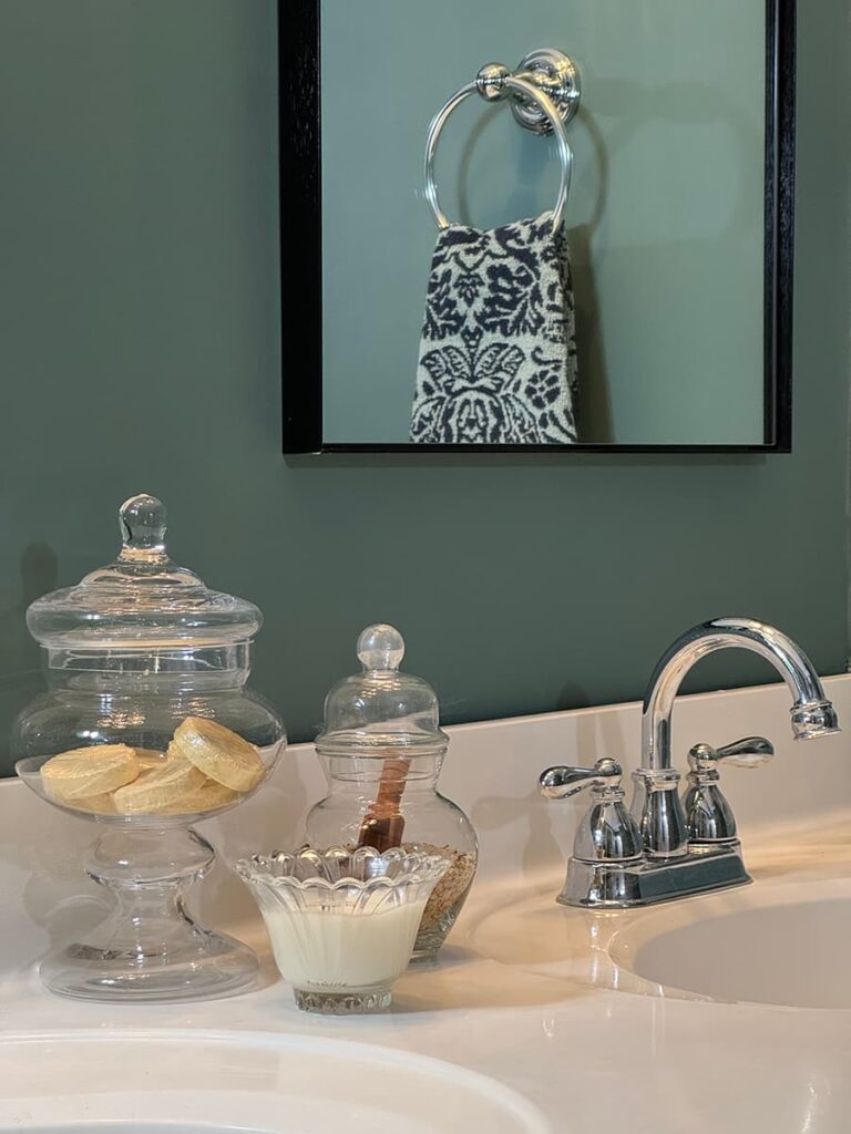 A bathroom vanity with chrome faucet