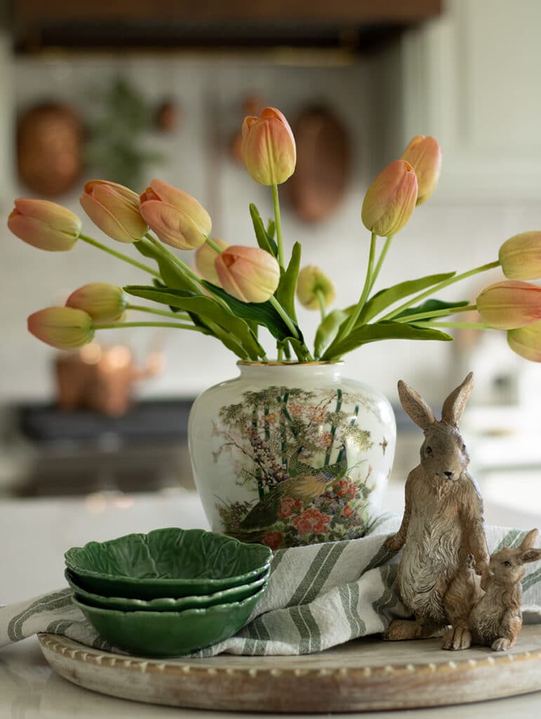 Coral tulips styled in a vase on a kitchen island