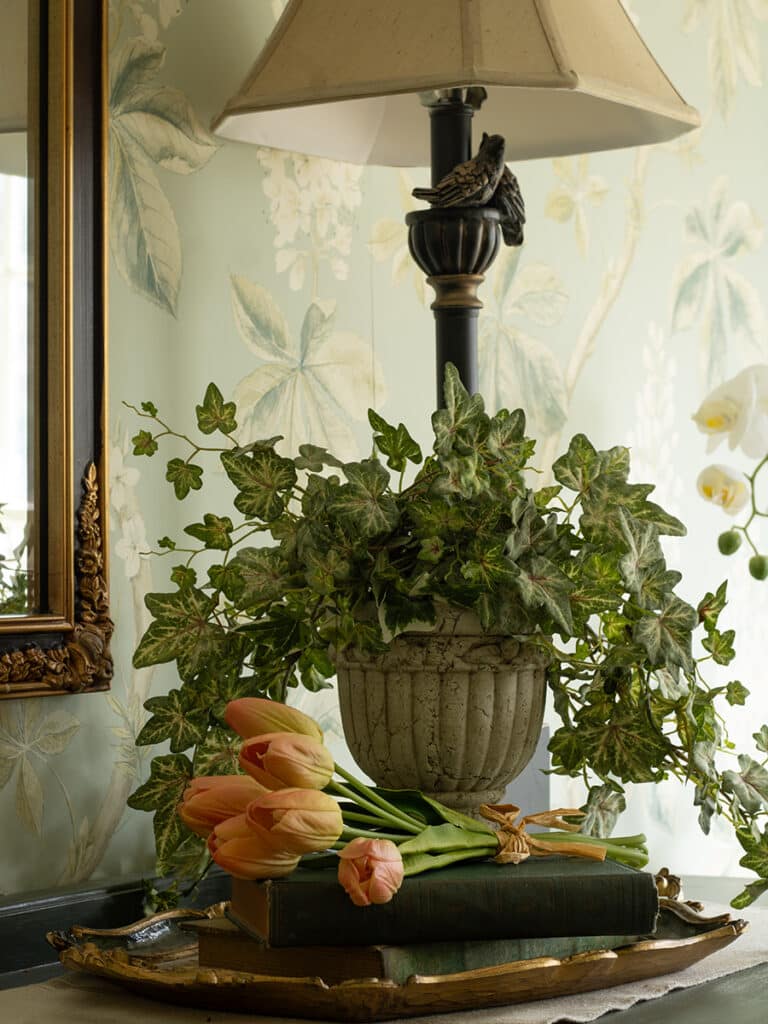 Faux tulips styled in a vintage style vignette on a dining room buffet