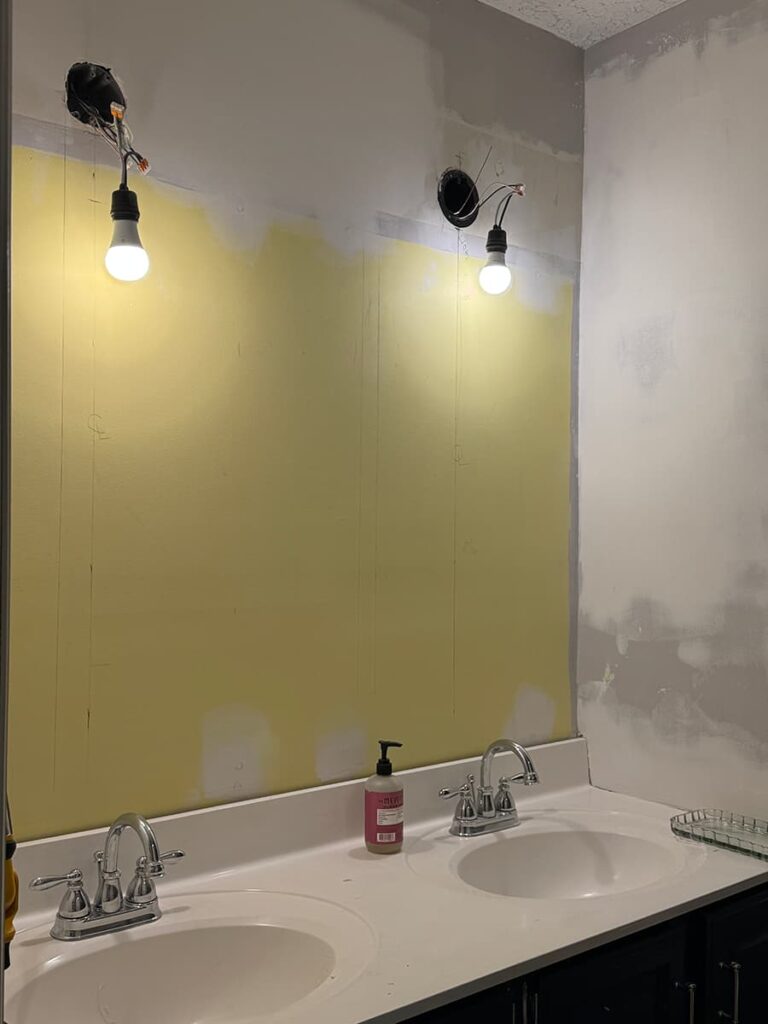 Temporary lights installed during a guest bathroom remodel