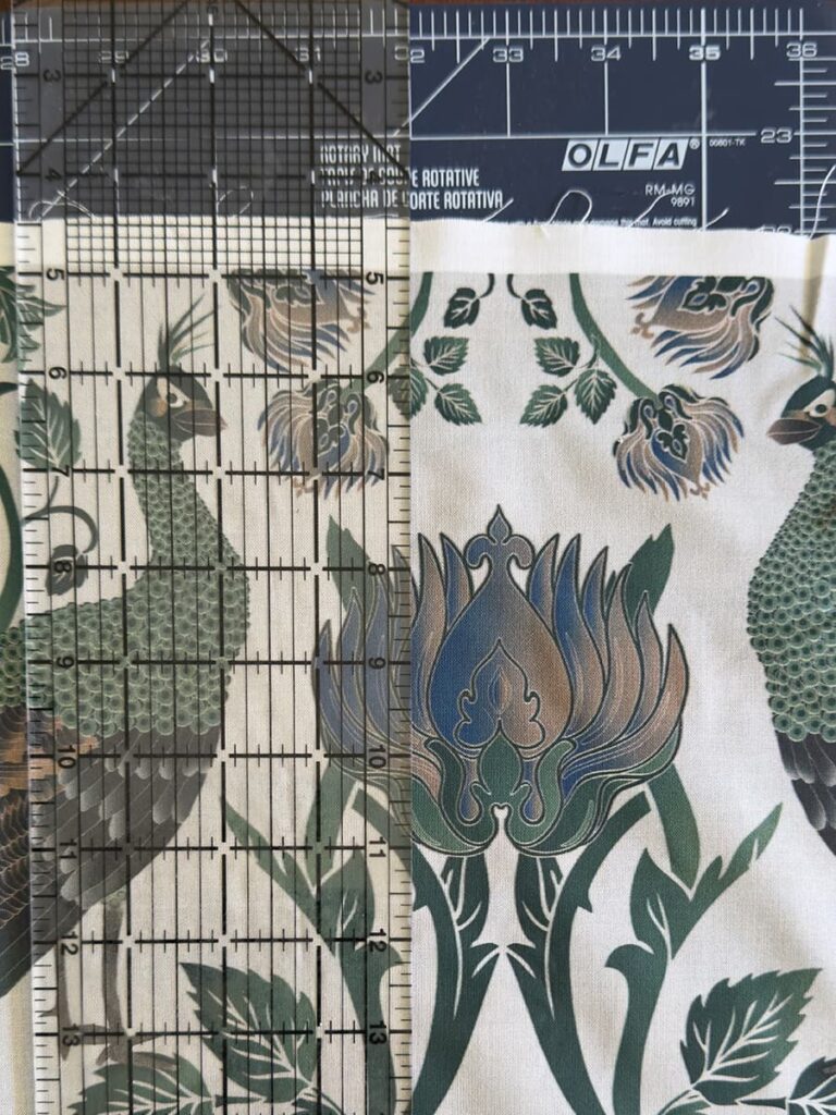 An image showing the use of a sewing mat and ruler to cut fabric