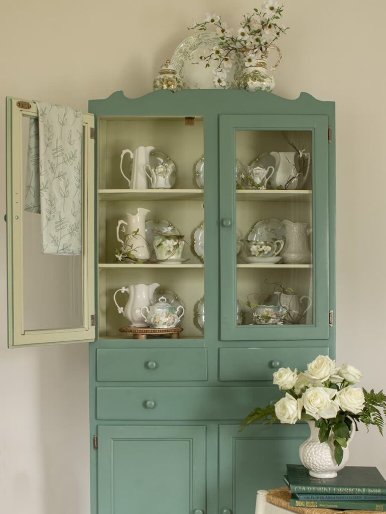 A jelly cupboard serves as a free standing piece of furniture in an English country kitchen