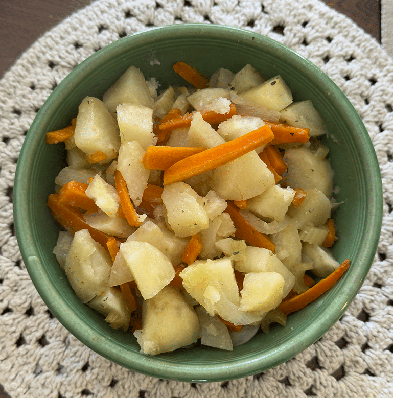 A bowl of roasted potatoes and carrots