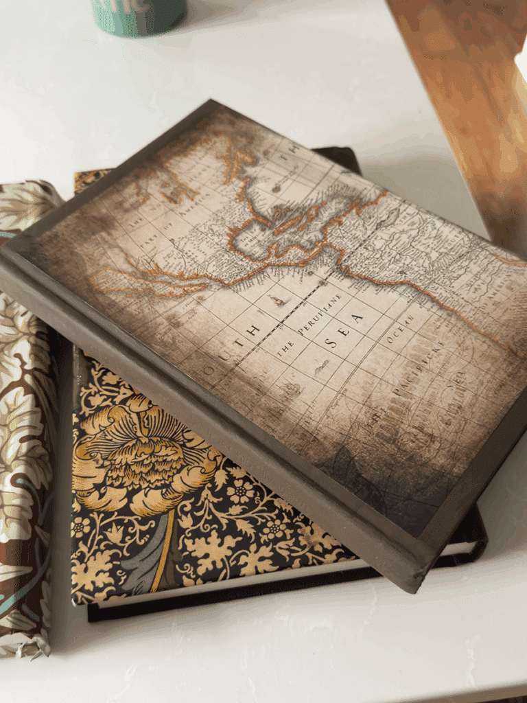A decorative book covered with a decorative map scrapbook page.